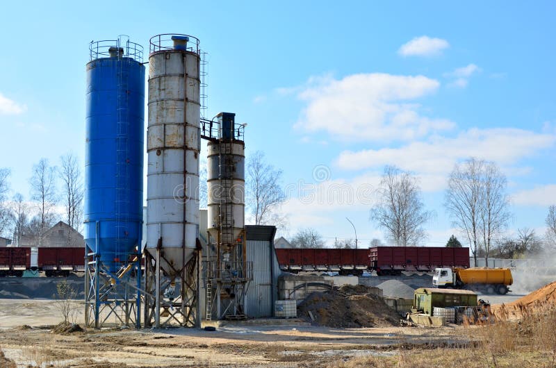 Concrete Batching Plant. Industrial producing cement for construction. Cement manufacturers mine and process raw materials and put them through a chemical reaction process to create cement. Concrete Batching Plant. Industrial producing cement for construction. Cement manufacturers mine and process raw materials and put them through a chemical reaction process to create cement