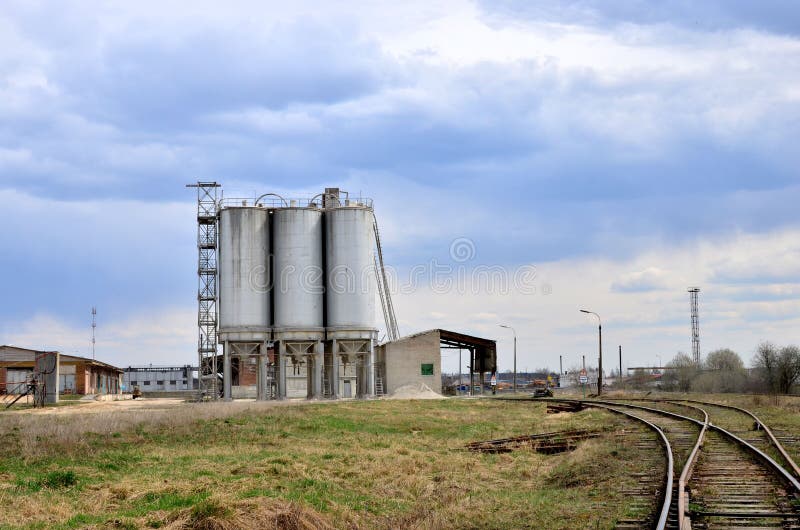 Concrete Batching Plant. Industrial producing cement for construction. Cement manufacturers mine and process raw materials and put them through a chemical reaction process to create cement. Concrete Batching Plant. Industrial producing cement for construction. Cement manufacturers mine and process raw materials and put them through a chemical reaction process to create cement