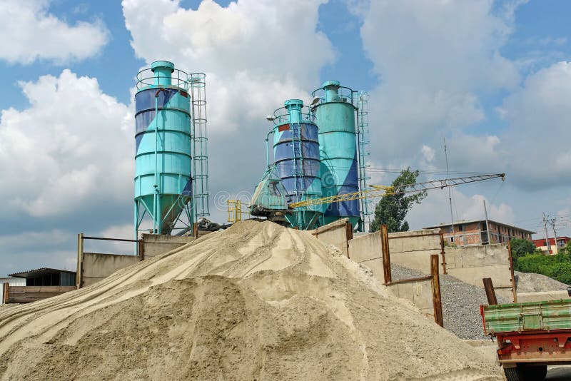 Concrete batching plant with three silos, heap of sand and gravel. Concrete batching plant with three silos, heap of sand and gravel