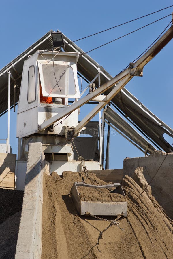 Close up of cabin and bucket with sand at concrete batching plant. Close up of cabin and bucket with sand at concrete batching plant