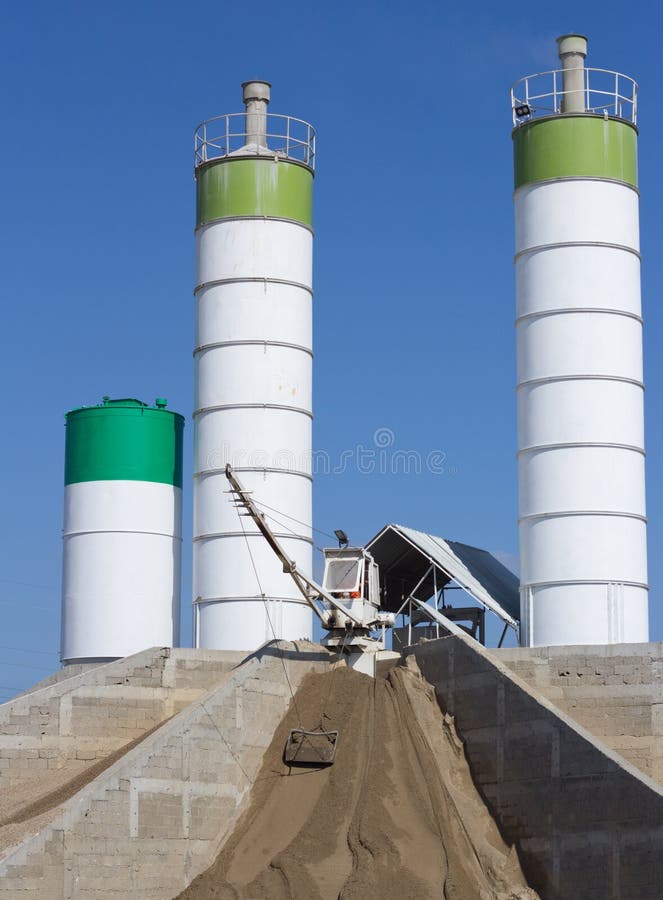 Concrete batching plant against blue sky. Construction industry. Concrete batching plant against blue sky. Construction industry