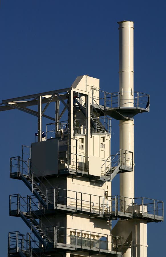 View at brand new asphalt batching plant on a blue sky. View at brand new asphalt batching plant on a blue sky