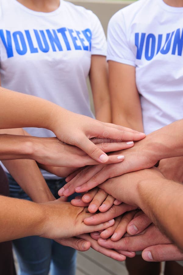 Volunteer group hands together showing unity. Volunteer group hands together showing unity