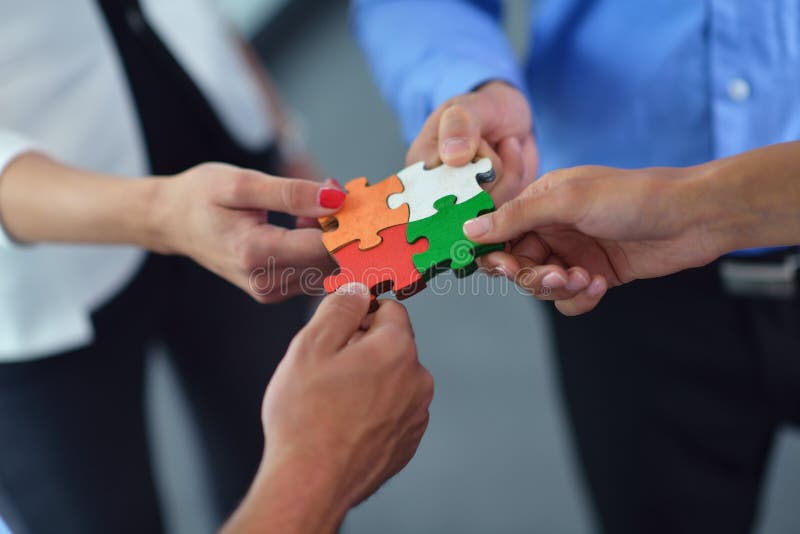 Group of business people assembling jigsaw puzzle and represent team support and help concept. Group of business people assembling jigsaw puzzle and represent team support and help concept