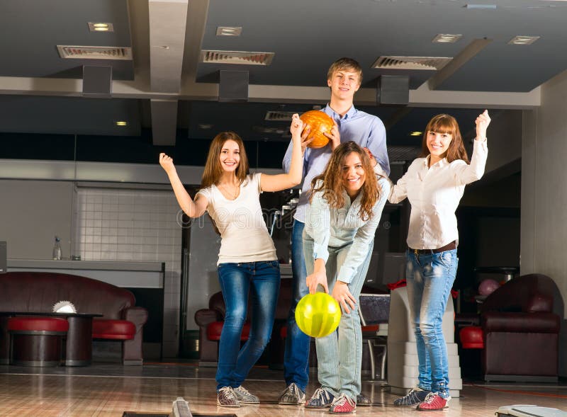 Gruppo di giovani amici che giocano bowling fotografie stock Gruppo di giovani amici che giocano bowling fotografie stock