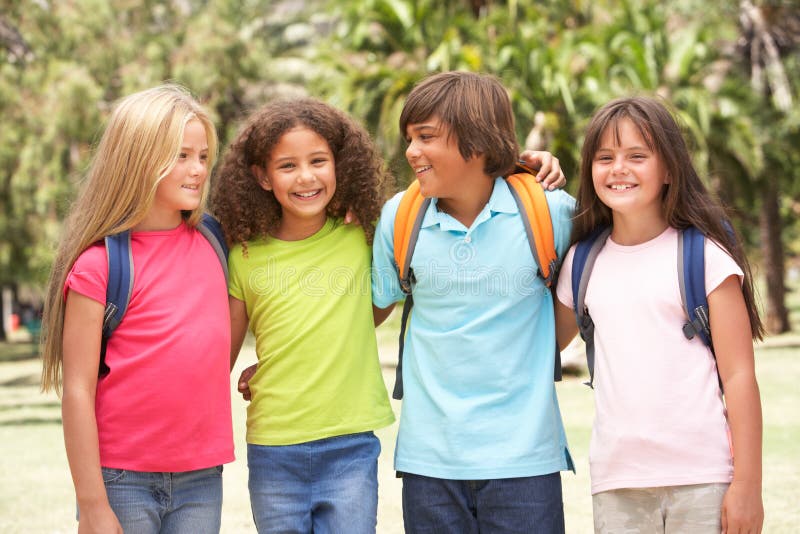 Group Of Schoolchildren Standing In Park Smiling. Group Of Schoolchildren Standing In Park Smiling