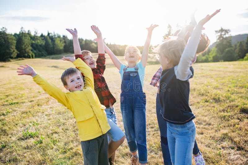 Portrait of group of school children standing on field trip in nature, playing. Portrait of group of school children standing on field trip in nature, playing.