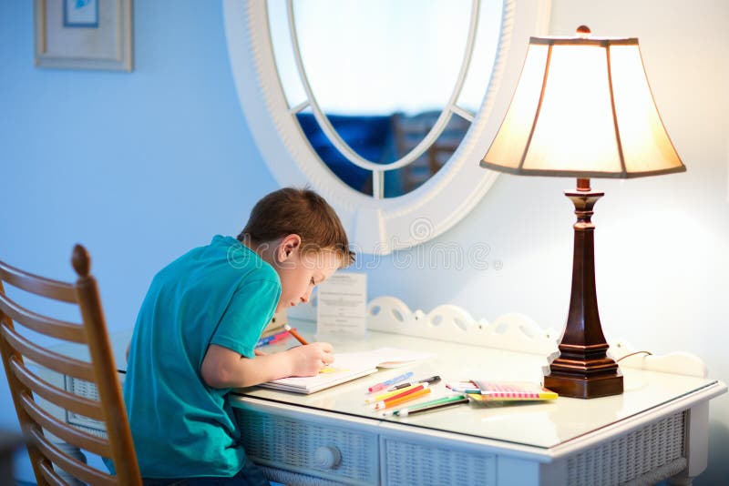 Portrait of cute happy schoolkid at home drawing or writing. Portrait of cute happy schoolkid at home drawing or writing