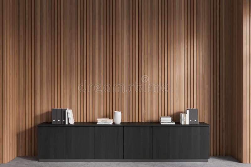 Front view of stylish dark gray file cabinet with books and folders on it standing in modern office with dark wooden walls and concrete floor. Concept of business interior. 3d rendering. Front view of stylish dark gray file cabinet with books and folders on it standing in modern office with dark wooden walls and concrete floor. Concept of business interior. 3d rendering