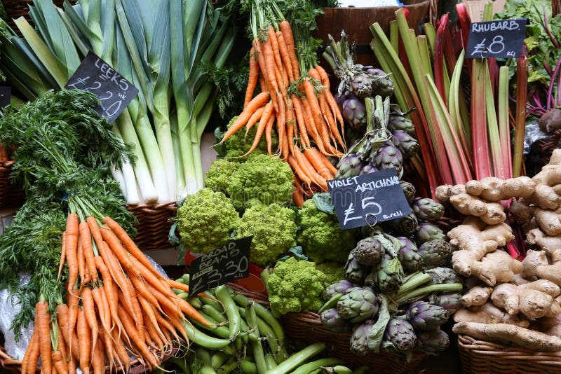 London Borough Market - carrots, leeks and artichoke at green grocer`s store. London Borough Market - carrots, leeks and artichoke at green grocer`s store.