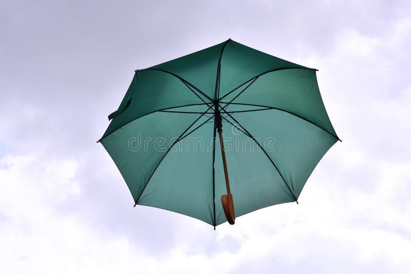 Grönt paraply som svävar i himlen royaltyfri fotografi Grönt paraply som svävar i himlen royaltyfri fotografi