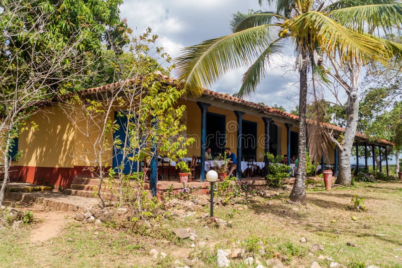 GUACHINANGO, CUBA - FEB 9, 2016: Tourists eat in an old hacienda Casa Guachinango in Valle de los Ingenios valley nea