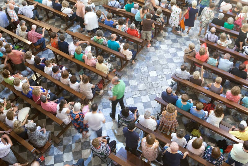 Guadalupe Monastery, Spain - September 09, 2018: People celebrating a mass in the temple of Guadalupe Monastery in Spain. Guadalupe Monastery, Spain - September 09, 2018: People celebrating a mass in the temple of Guadalupe Monastery in Spain