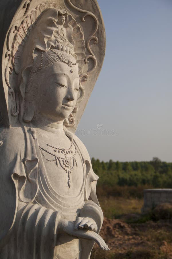 Guan Yin The Goddess Of Mercy Statue With Sky Background Stock Photo