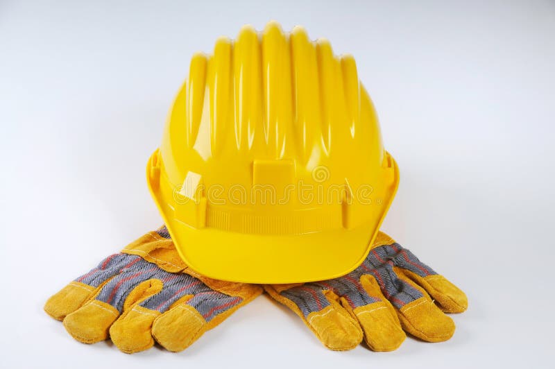 Guantes amarillos del sombrero duro y del trabajo fotos de archivo libres de regalías Guantes amarillos del sombrero duro y del trabajo fotos de archivo libres de regalías