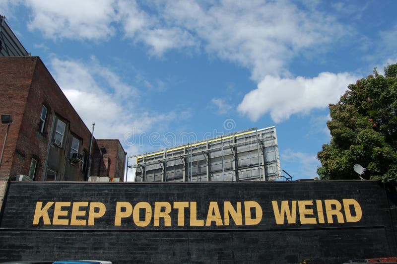 `Keep Portland Weird` is painted on the back wall of Dante`s in Portland Oregon, with a blue sky and white clouds in the background. `Keep Portland Weird` is painted on the back wall of Dante`s in Portland Oregon, with a blue sky and white clouds in the background.