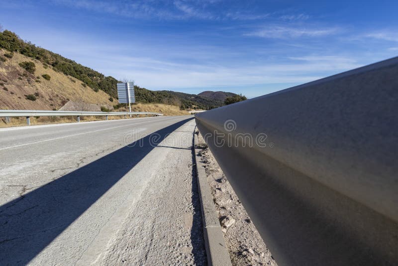 Guardrail on a tarmac road blue sky landscape royalty free stock photo Guardrail on a tarmac road blue sky landscape royalty free stock photo
