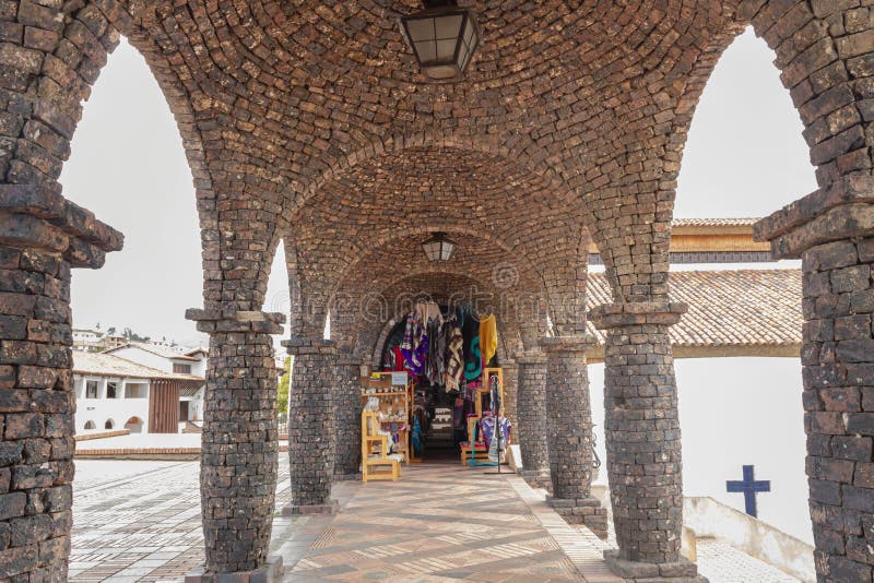 Guatavita gift shop under brick arc and pillars structure alley near to church