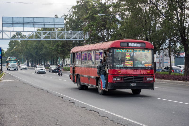 GUATEMALA - NOVEMBER 11, 2017: Guatemala City Street with Traffic. Daily View of Public Transport, like Colorful Chicken Bus, Taxi stock image GUATEMALA - NOVEMBER 11, 2017: Guatemala City Street with Traffic. Daily View of Public Transport, like Colorful Chicken Bus, Taxi stock image
