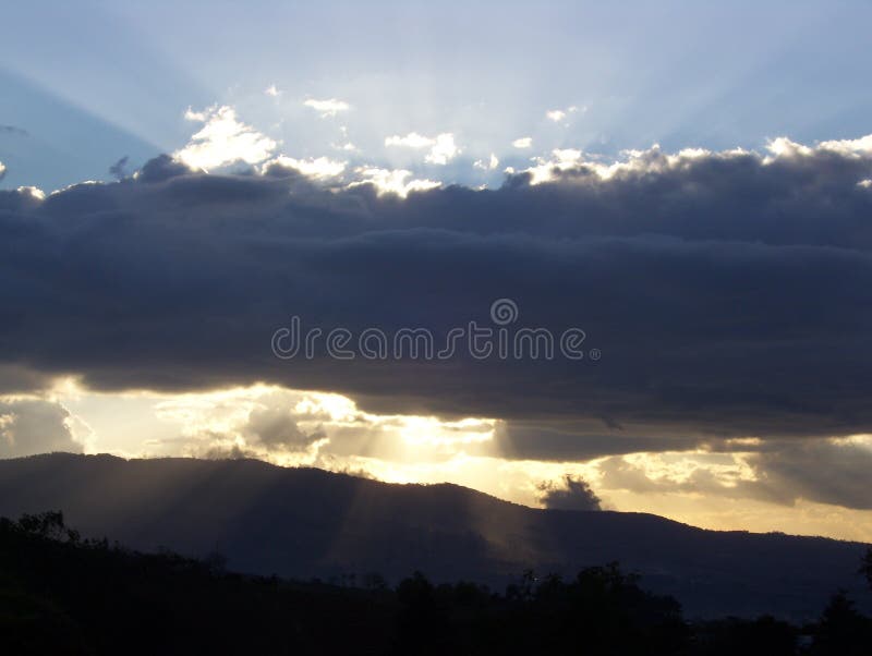 A picturesque view of the sun dipping beneath the clouds in an orphanage in the village of Tululche in Guatemala. A picturesque view of the sun dipping beneath the clouds in an orphanage in the village of Tululche in Guatemala