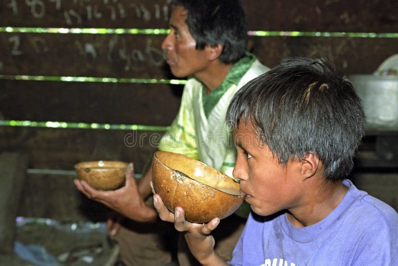 Guatemalan father and son drinking coconut milk