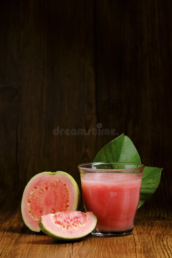 Guava juice is served on a wooden background