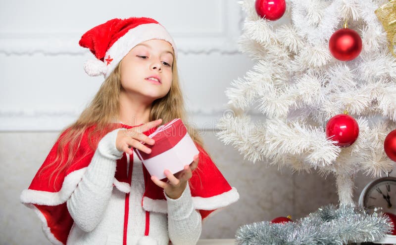 Guess what inside box. Winter holiday tradition. Kid with christmas present. Reason children love christmas. Girl royalty free stock images Guess what inside box. Winter holiday tradition. Kid with christmas present. Reason children love christmas. Girl royalty free stock images