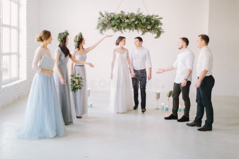 Guests Throwing Confetti Over Bride and Groom at Wedding Stock Photo
