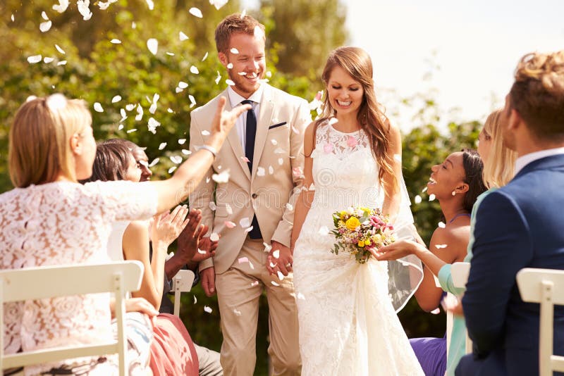 Guests Throwing Confetti Over Bride And Groom At Wedding