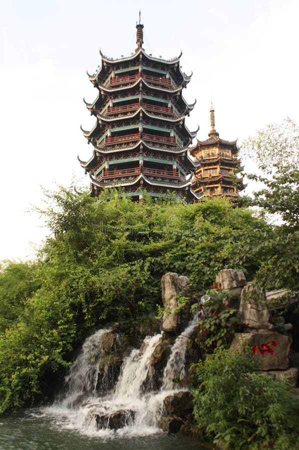 Two Pagodas of Sun and Moon and a waterfall at the lake in Guiling, China. Two Pagodas of Sun and Moon and a waterfall at the lake in Guiling, China