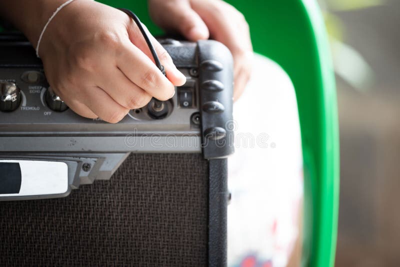 Guitar Electric Amplifier. Rock Overdrive Effect. Hand is Plugging a Cable into Jack Stock Photo