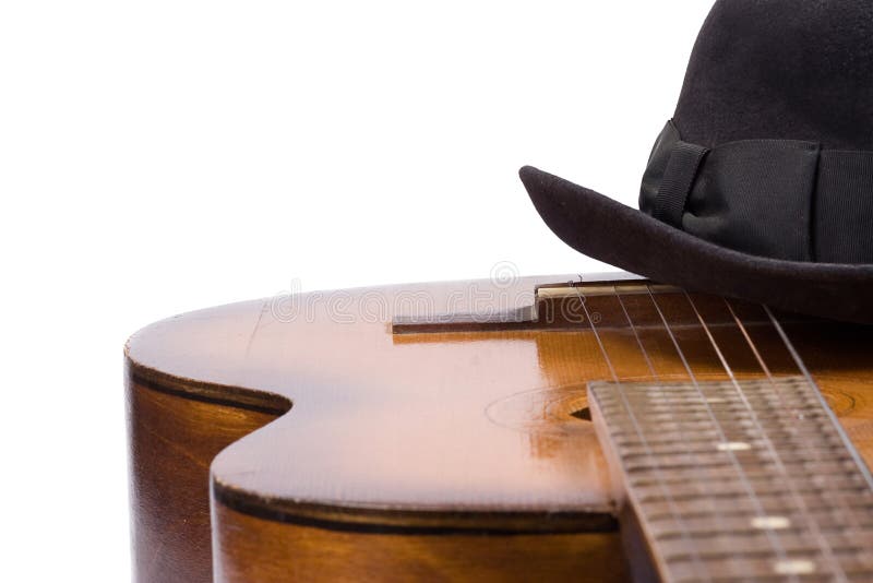 Guitar and hat on white