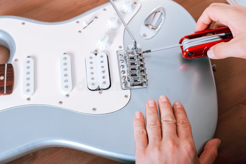 Guitar Master Adjusting Bridge Saddle on Tremolo of Electric Guitar