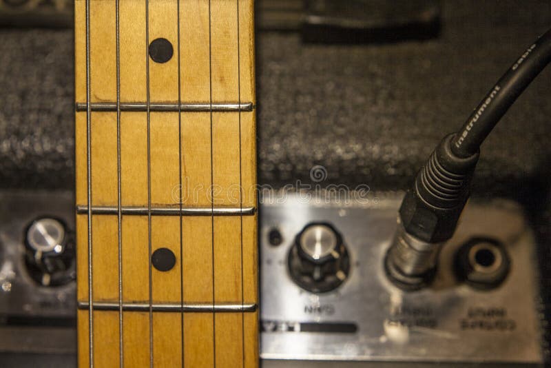 Guitar Neck Over Amplifier Device and Audio Cord Stock Image Image of