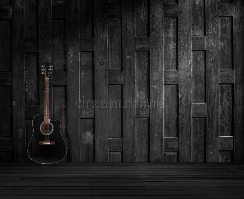 Guitar on old wooden wall.