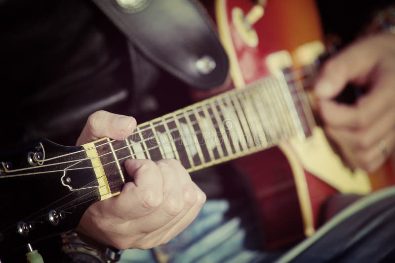 Closeup of a guitar player in vintage tone