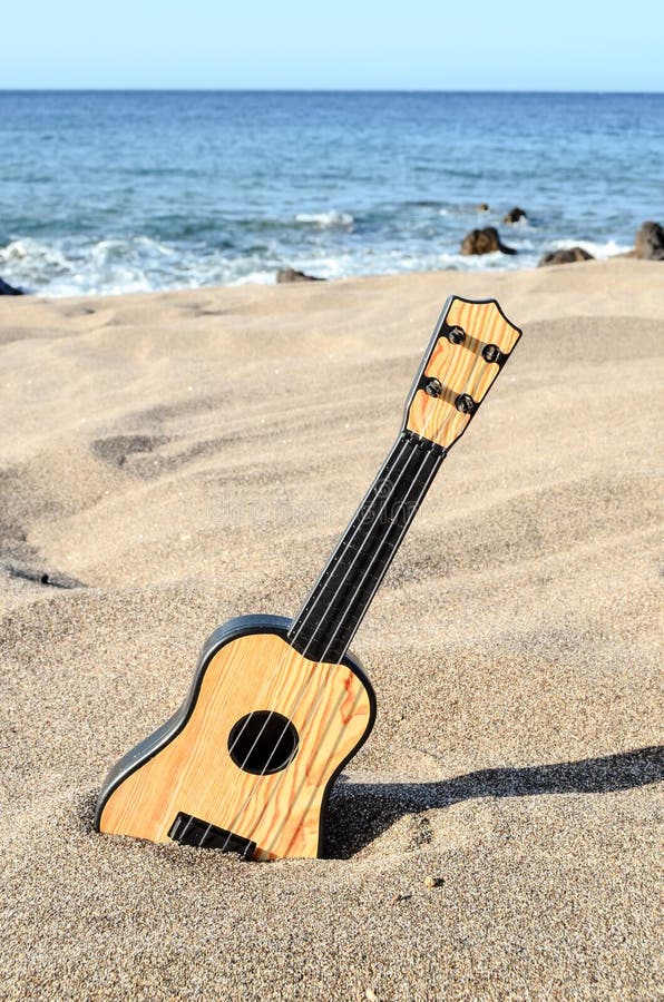 Guitar on the Sand Beach stock photo. Image of rare, resort 65967114
