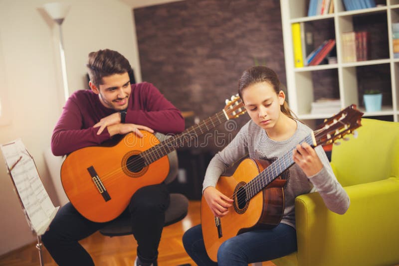 Guitar Teacher Teaching the Little Girl Stock Photo Image of music