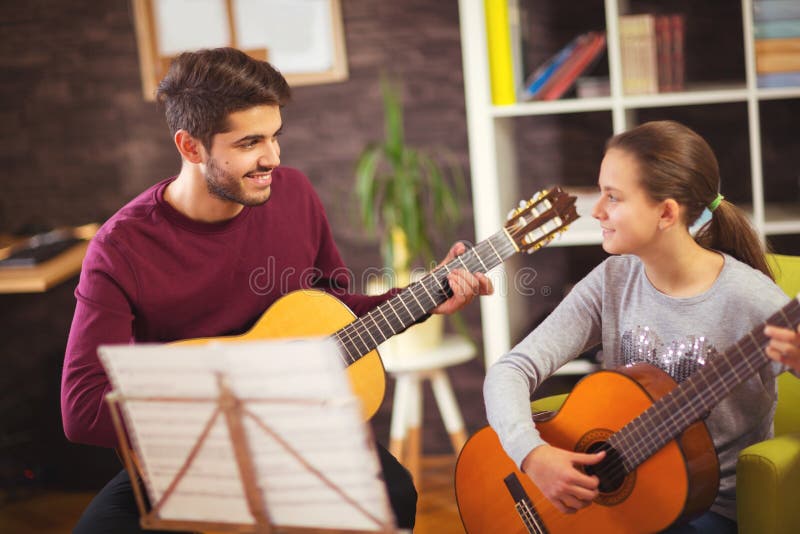 Guitar Teacher Teaching the Little Girl Stock Image Image of