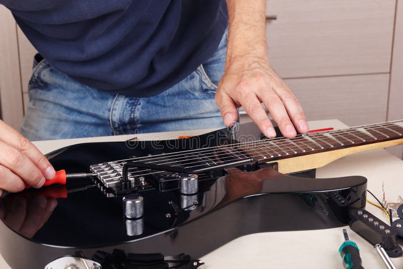 Guitar Technician Adjusts Tremolo Bridge on Modern Electric Guitar Stock Photo Image of