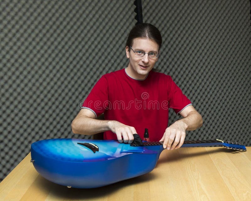Guitar Technician is Measure the Height of the Guitar String. Stock Photo Image of craft