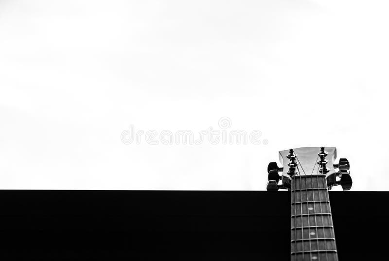 Guitar in a window. White background. Selective focus. B