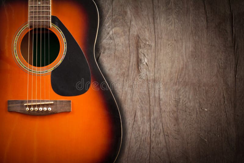 Guitare acoustique se reposant sur un fond grunge vide avec c photo libre de droits Guitare acoustique se reposant sur un fond grunge vide avec c photo libre de droits