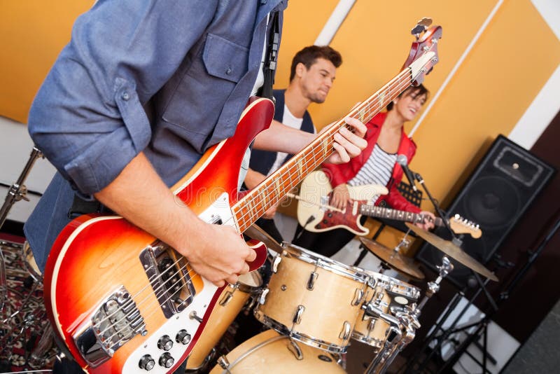 Guitarist Performing with Band in Recording Studio Stock Photo Image