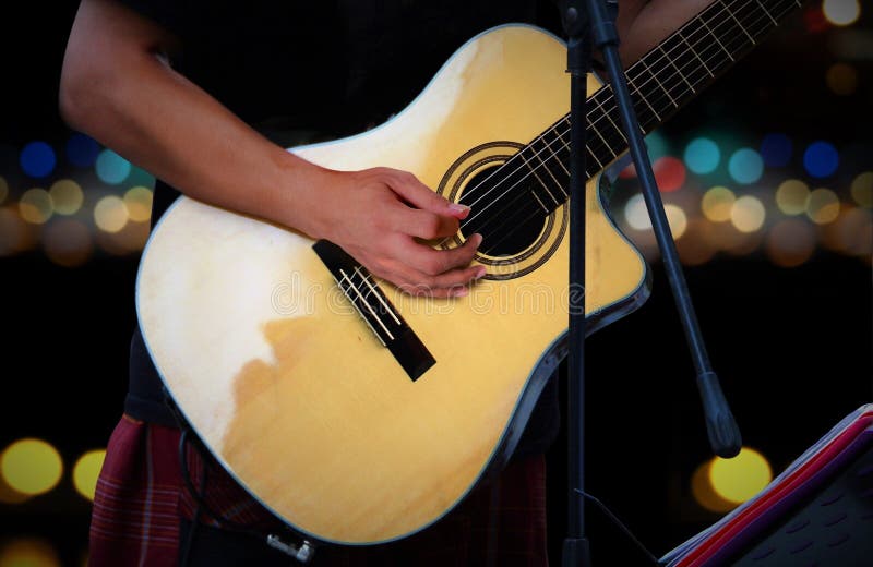 Guitarist Playing Acoustic Guitar with Blur Lights Stock Photo Image