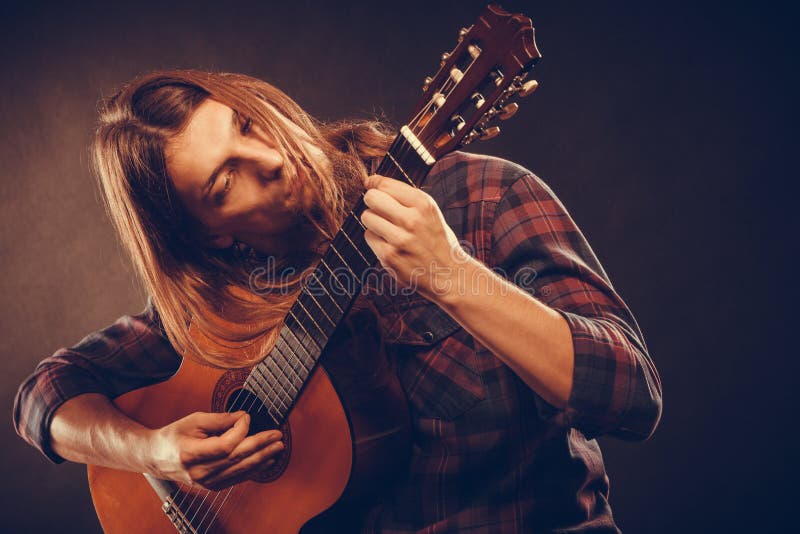 Guitarist is playing the guitar.