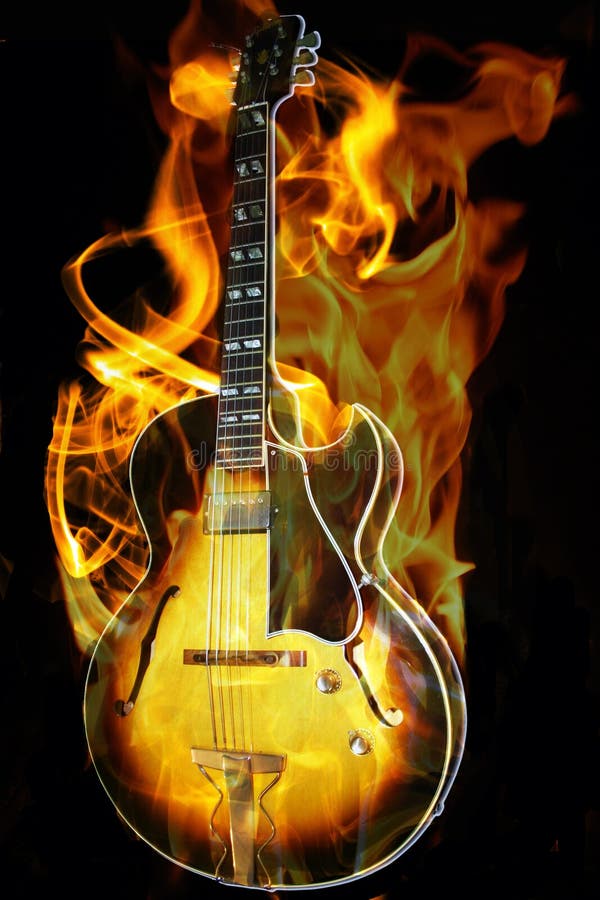 A image of a guitar on fire isolated on black background. A image of a guitar on fire isolated on black background.