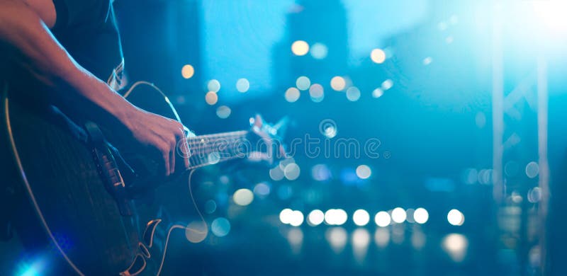 Guitarist on stage night for background, blue tone soft and blur concept. Guitarist on stage night for background, blue tone soft and blur concept