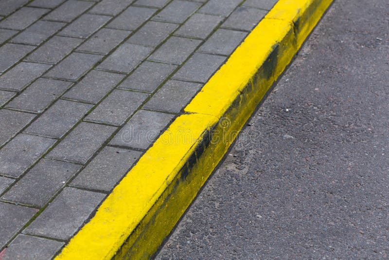 Yellow kerb line on the asphalt proad. Yellow kerb line on the asphalt proad