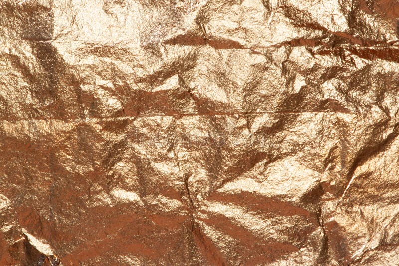 Guld- ljus skinande textur av ett skrynkligt ark arkivfoto